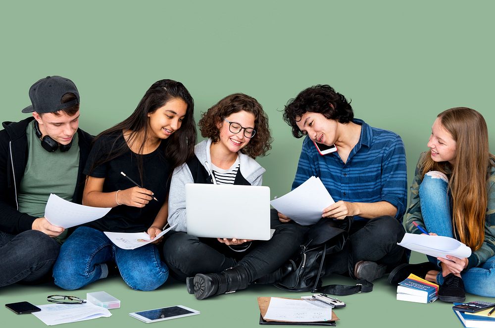 Group of Diverse High School Students Reading Text Book Tutorial