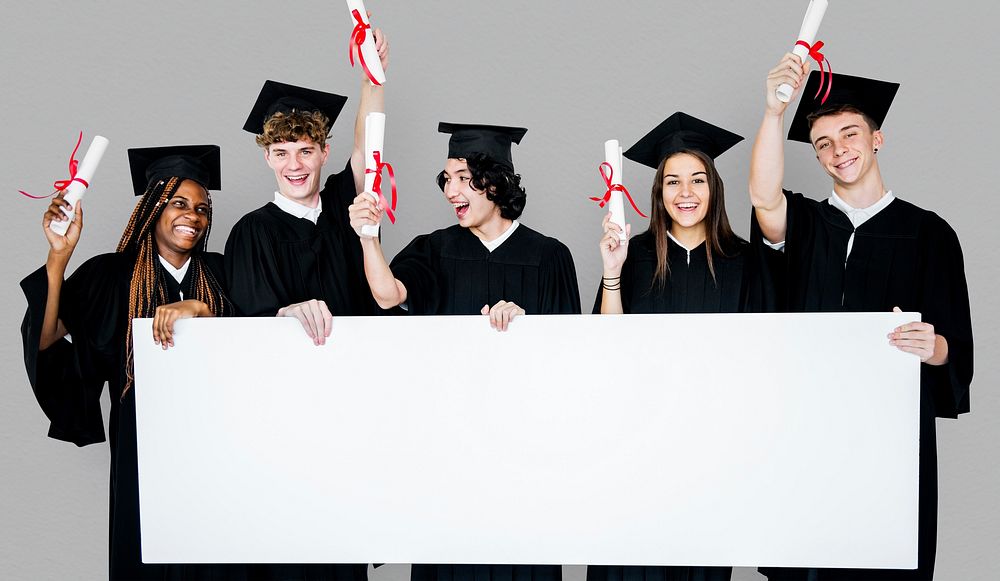 Diverse Students wearing Cap and Gown Showing Blank Copy Space Studio Portrait