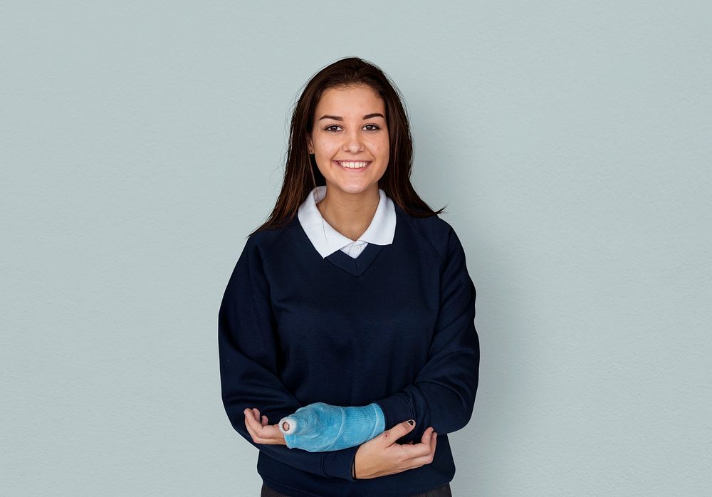 Young Student in Uniform with Broken Arm Studio Portrait