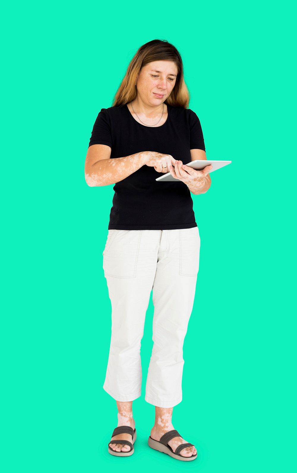 Caucasian woman full body standing and using digital tablet