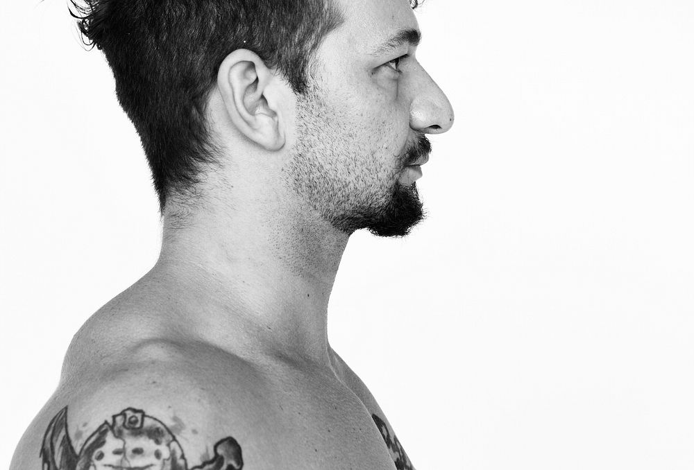 Shirtless guy with tattoo on white background