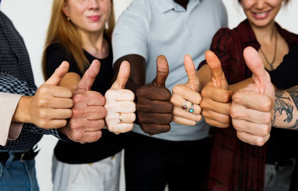 Group of people thumps up agreement support together