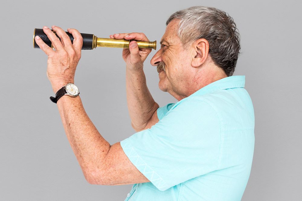 Senior Adult Man Looking Through Spyglass Telescope Studio Portrait