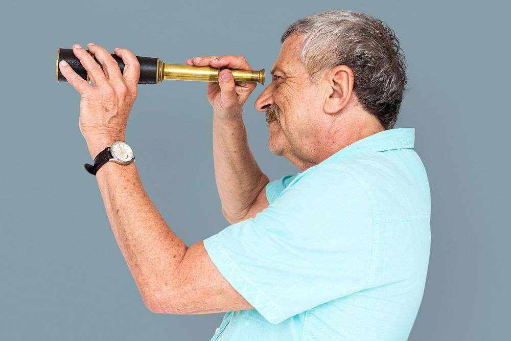 Senior Adult Man Looking Through Spyglass Telescope Studio Portrait