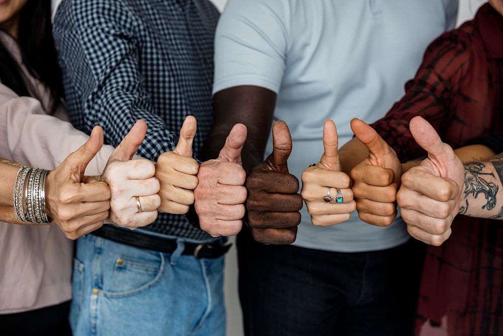 Group of people thumps up agreement support together