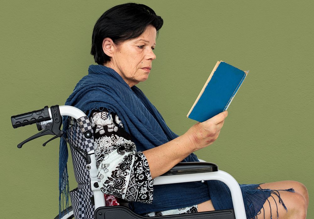 Disable Adult Woman Reading Book on Wheelchair Studio Portrait
