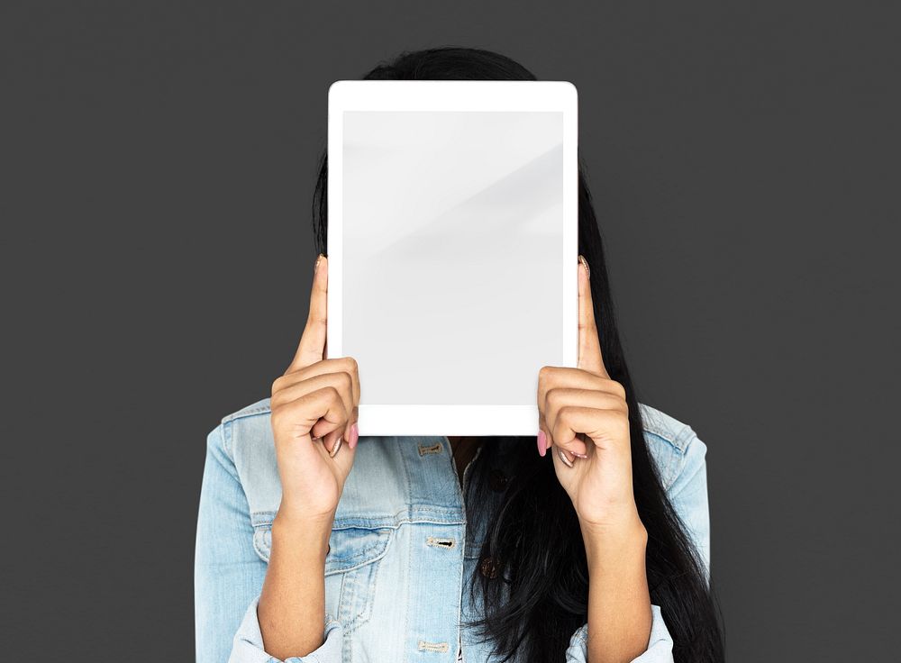 Woman using digital tablet covering her face