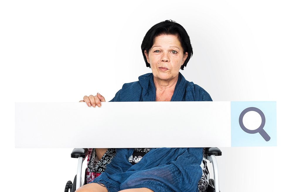 Senior adult woman on wheelchair holding searching banner