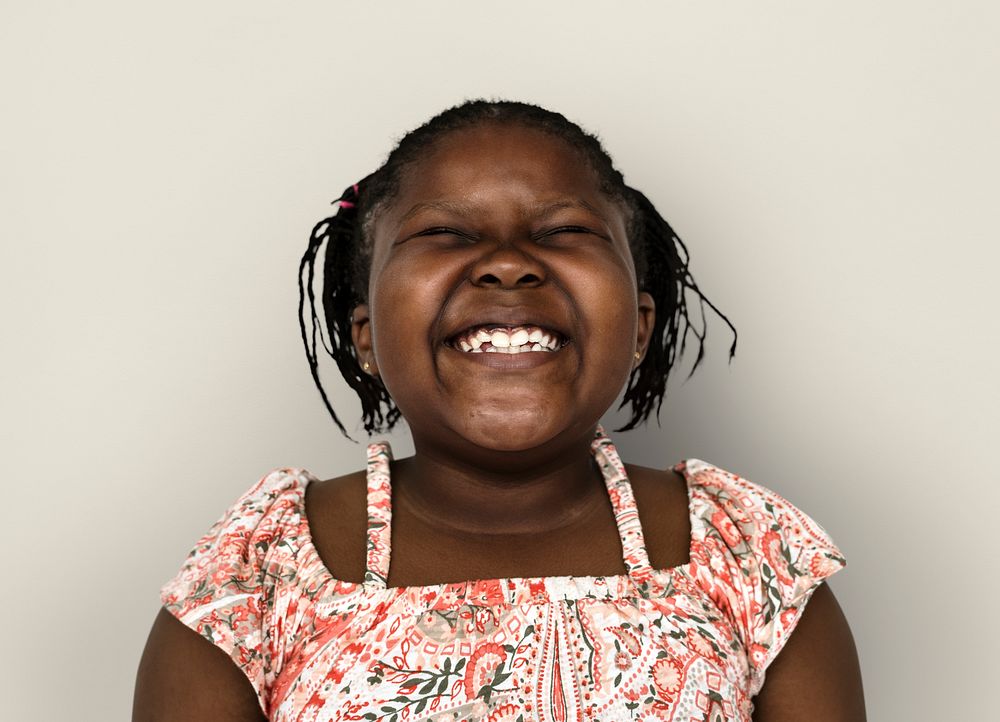 Little african girl smiling casual studio portrait