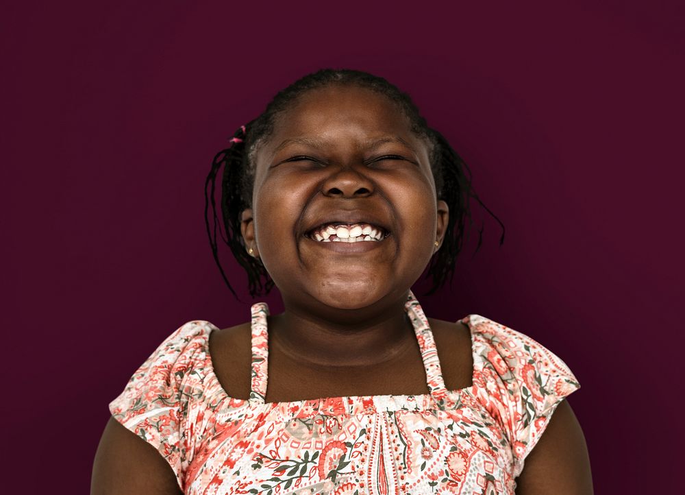 Little african girl smiling casual studio portrait
