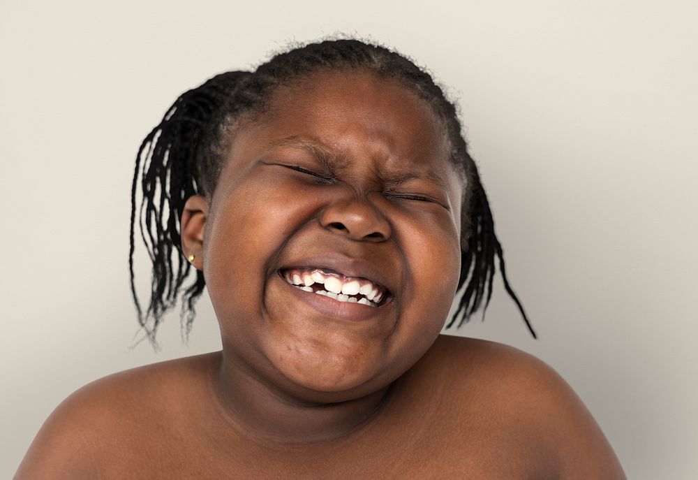 Little african girl smiling shirtless studio portrait