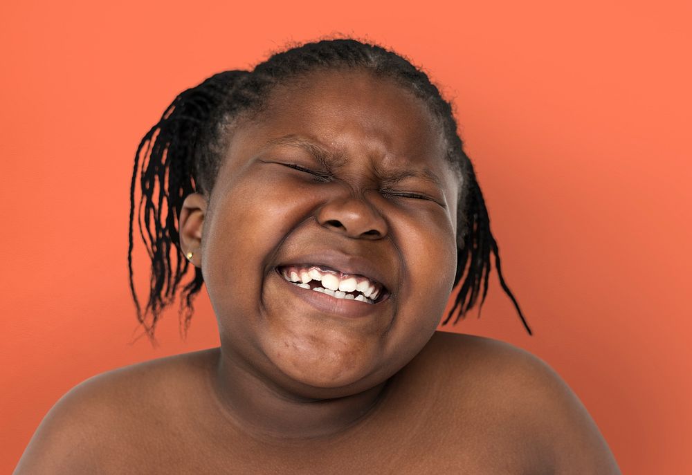 Little african girl smiling shirtless studio portrait