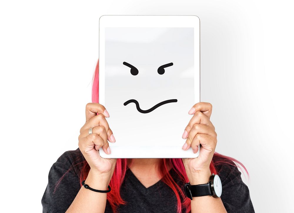 Woman holding digital tablet with moody face cover her face