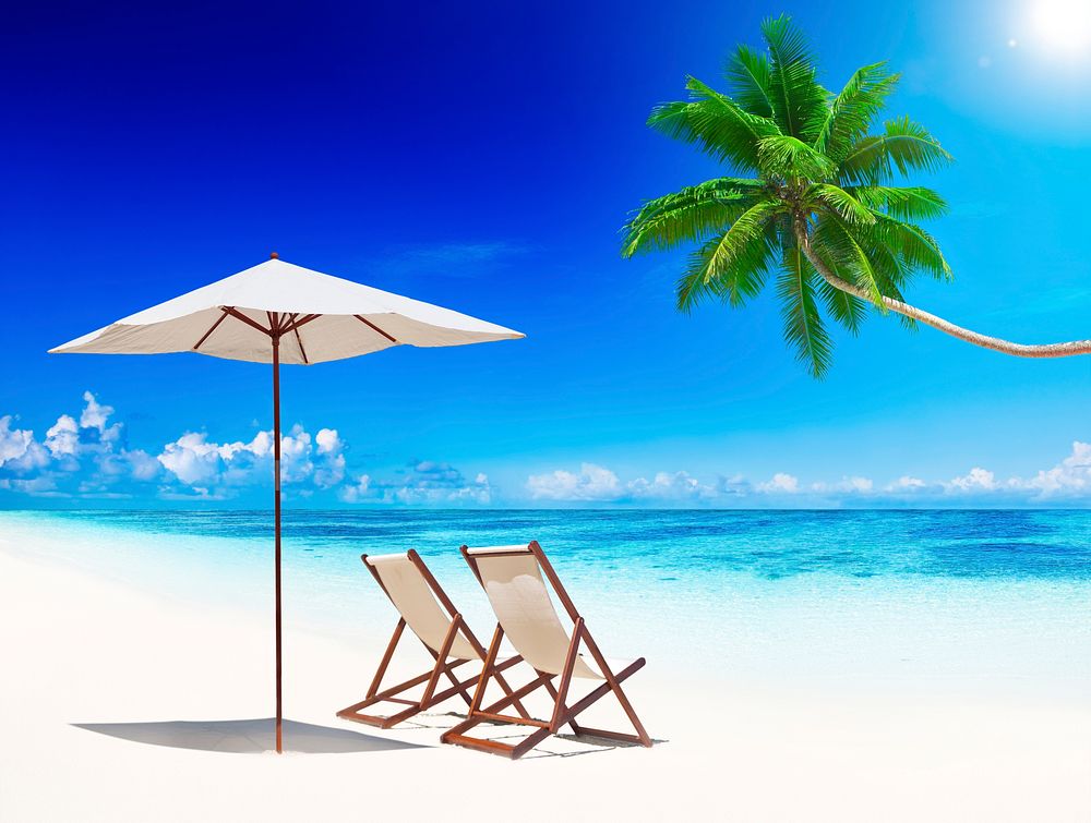 Deck chairs on tropical beach.