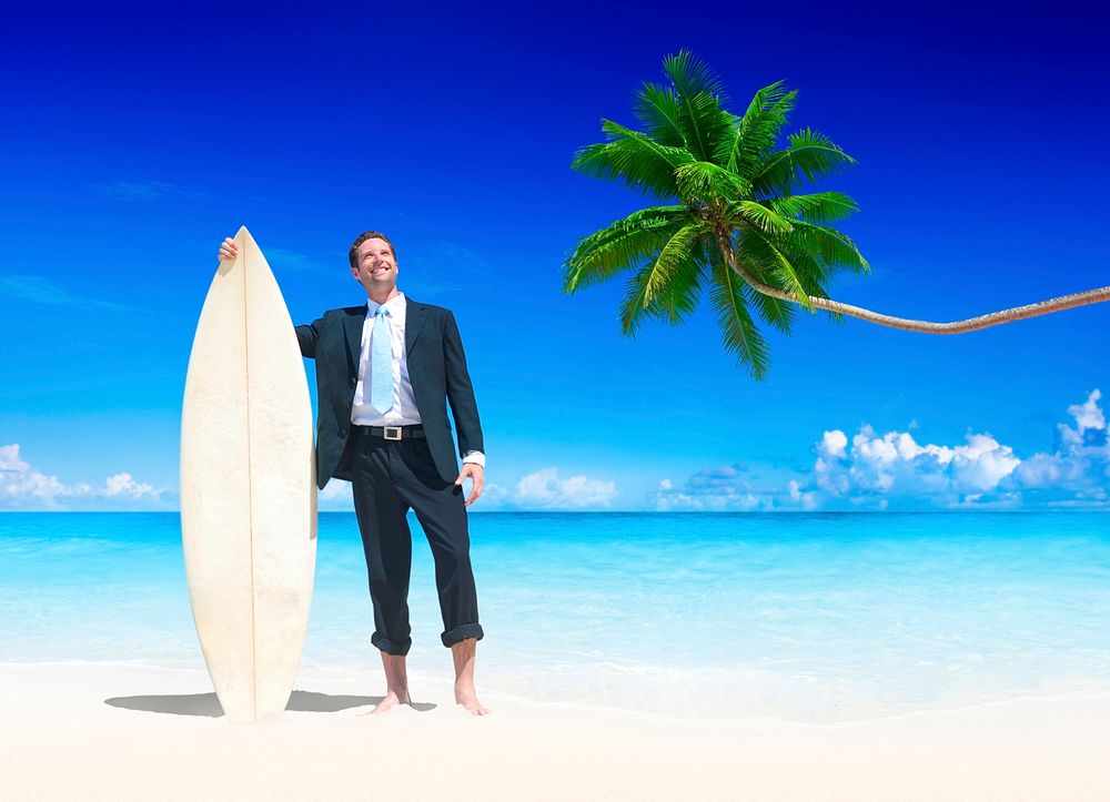 Businessman with surfboard on the beach.
