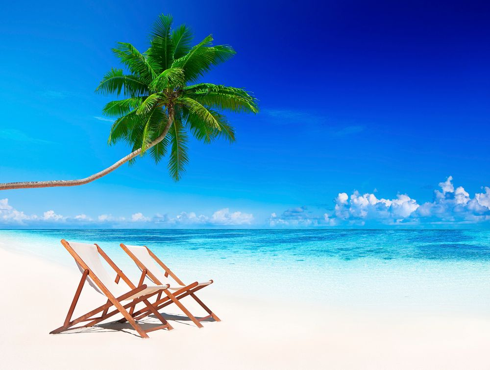 Deck chairs on tropical beach.
