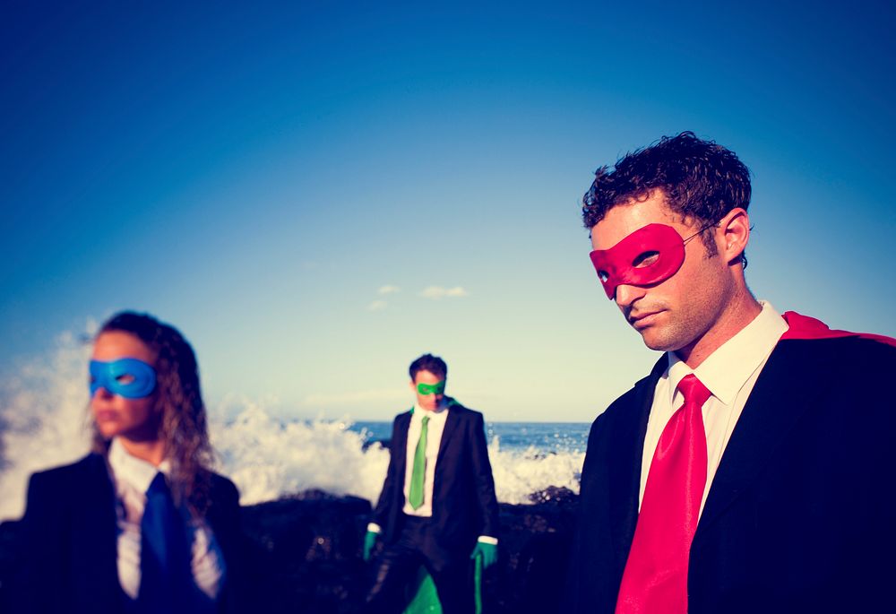 Business superheroes on the beach.