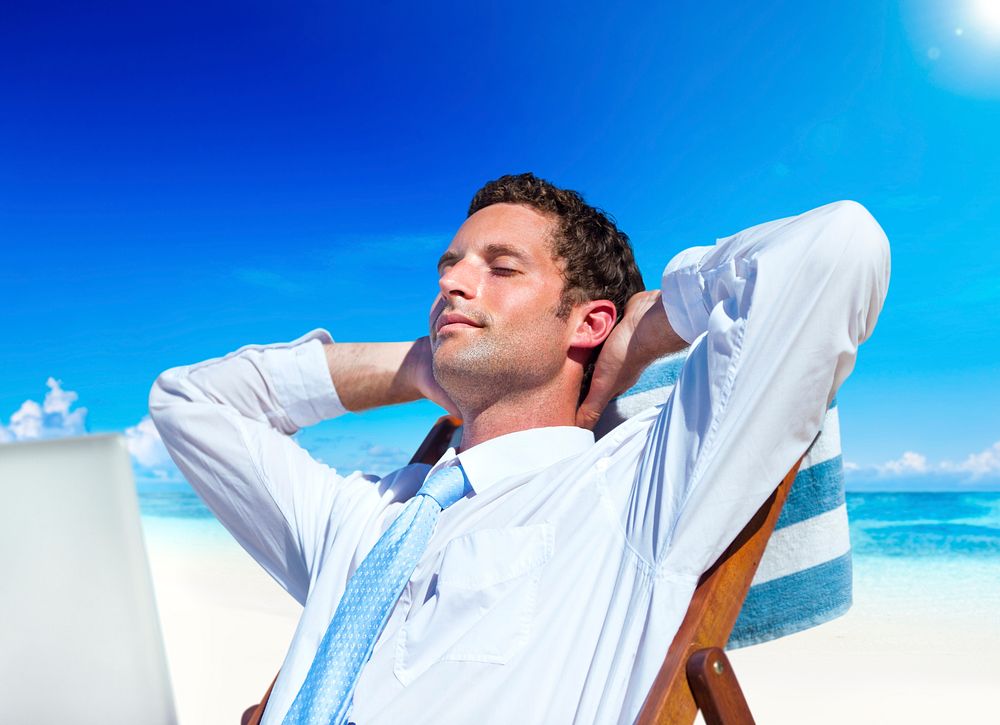 Businessman relaxing on the beach.