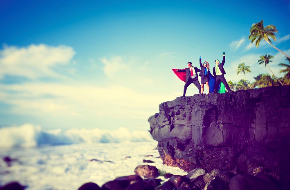 Business superheroes on the edge of a cliff