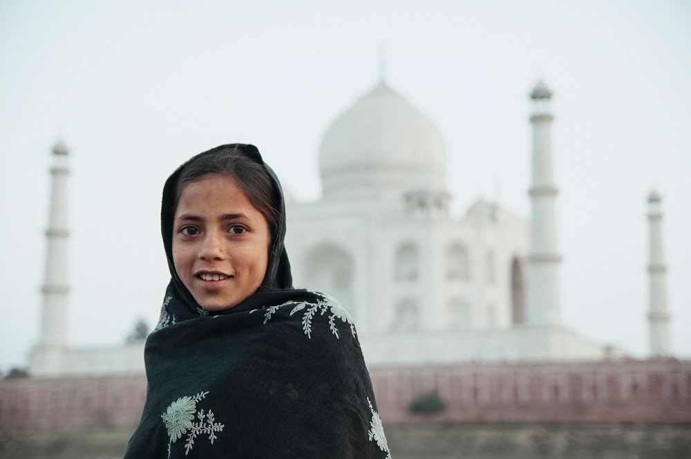 A girl smiling at the camera, Taj Mahal, India