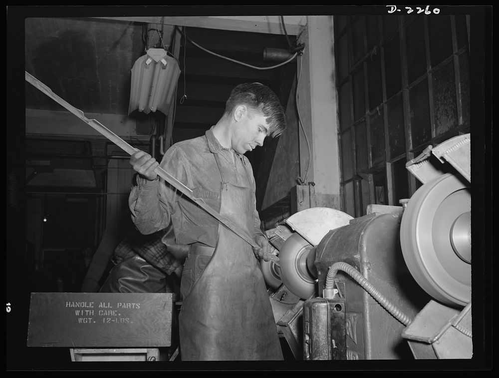Bantam, Connecticut. Buffing aluminum supports for bomber seats is nineteen-year-old Gerard Gervais, who came to Bantam in…