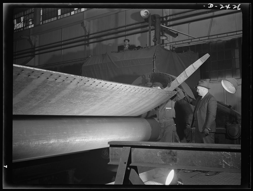 Shipbuilding. "Liberty" ships. This giant plate roller, of German design, is used to roll cold steel shell plates for…