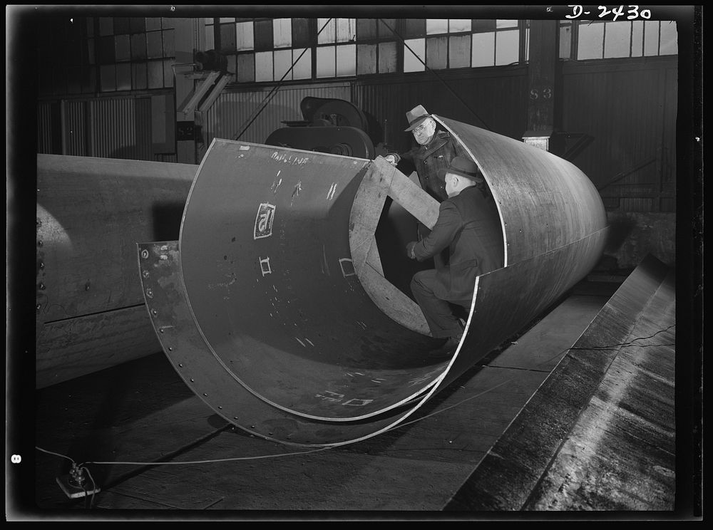 Shipbuilding. "Liberty" ships. These are rolled plates for the shaft tunnel of one of Uncle Sam's new "Liberty Ships," under…