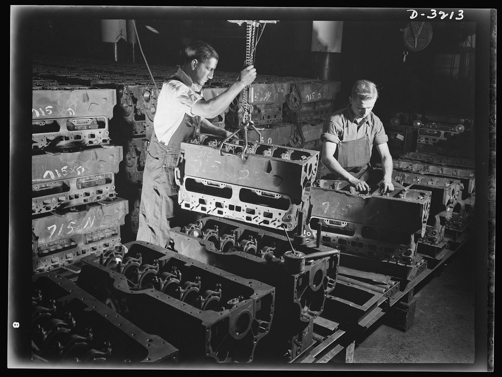 Halftrac scout cars. Laying the foundation of another power plant for an Army halftrac scout car. An engine block, already…