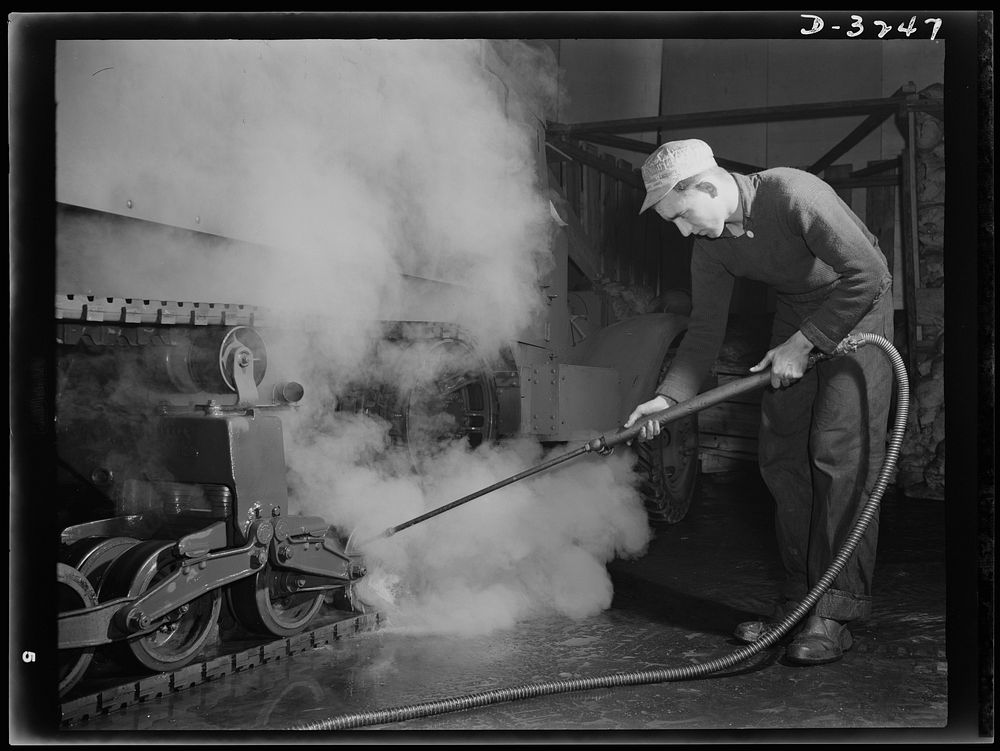 Steam cleaning an Army halftrac scout car for final painting. One of the last touches a large Midwest plant gives the cars…