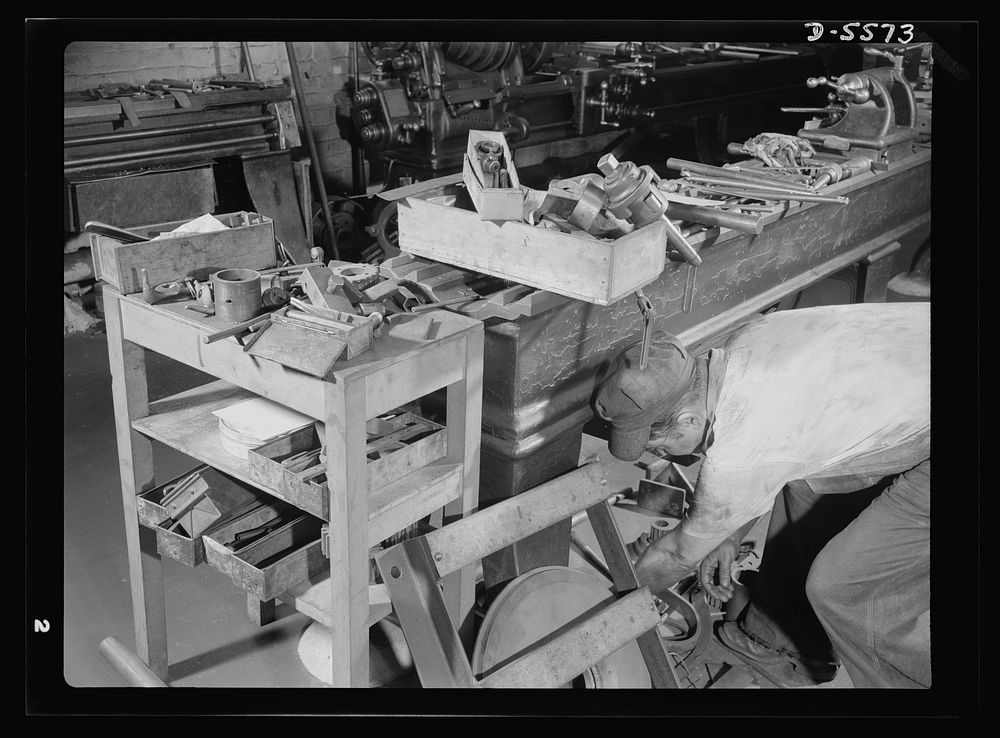 Industrial safety. Accident prevention. A cluttered work bench is hazardous. This worker could be seriously injured by…