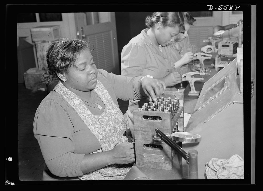 Production. Aircraft engines. African American women with no previous industrial experience are reconditioning used spark…