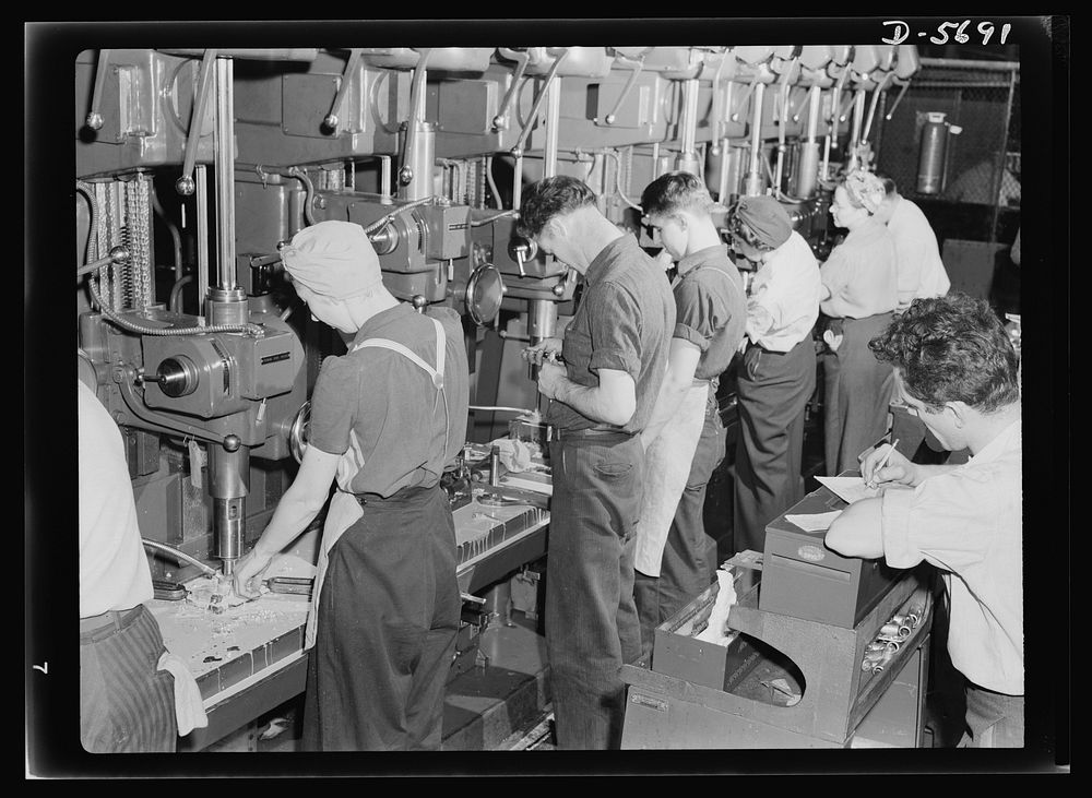 Production. Willow Run bomber plant. Drill press lineup, 1943 style. Both men and women man the machines which are turning…