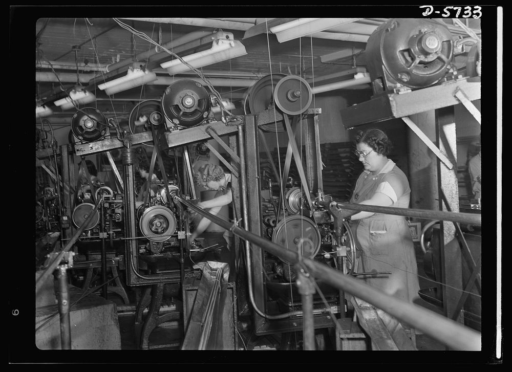Women in industry. Tool  production. The hum of whirling machinery accompanies the work of these women cut-off machine…