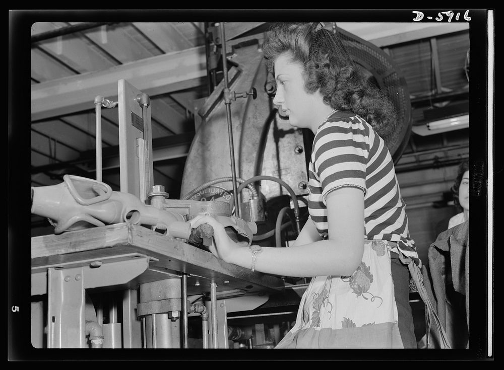 Women in industry. Gas mask production. She used to wrap bread in a bakery, before Pearl Harbor, but today twenty-one-year…