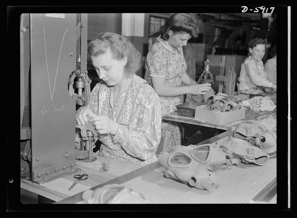 Women in industry. Gas mask production. Formerly employed in a vacuum cleaner plant, these young women are now making gas…