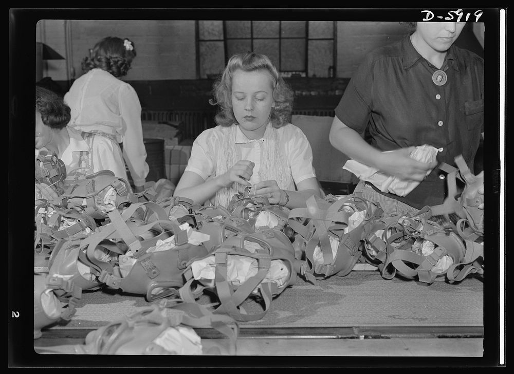 Women in industry. Gas mask production. Lacing head harnesses of gas masks after they have passed through all the stages of…