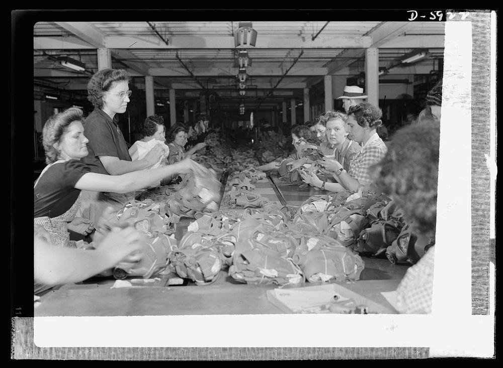 Women in industry. Gas mask production. The finished gas mask face pieces in the foreground were just flaps of rubber…