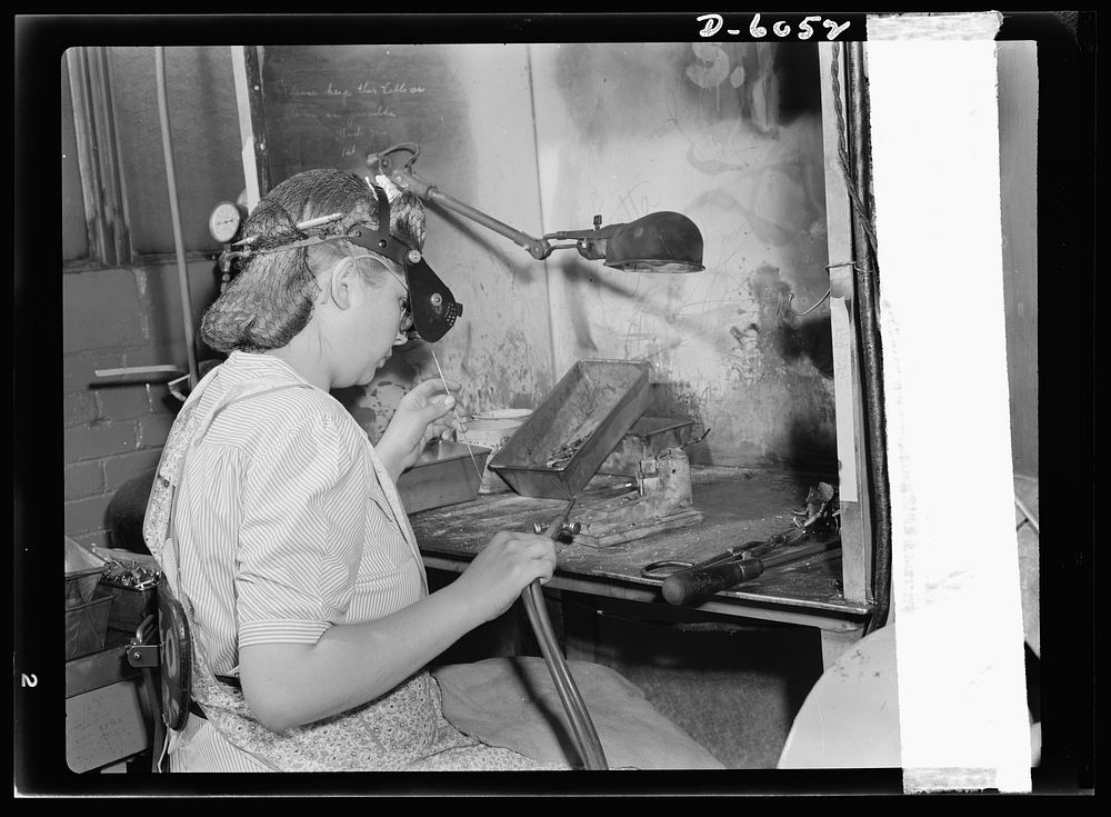 Women in war. Machine gun production operators. She carries a torch for the men of America's armed forces! Blonde, twenty…
