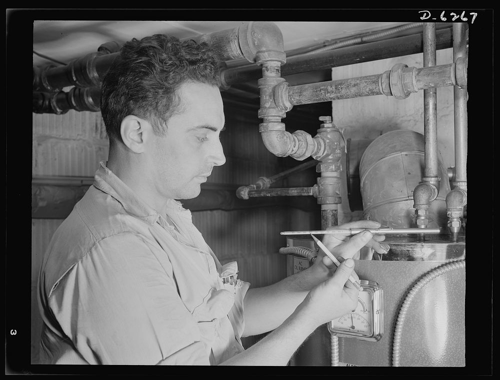 Fuel oil conservation. An experienced serviceman checks the efficiency of the family heating plant. This man measures the…