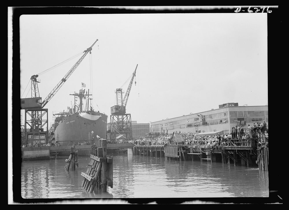 Ship launching in Portland, Maine. Spectators crowded the docks when Ocean Seaman, one of five lend-lease cargo-carrying…