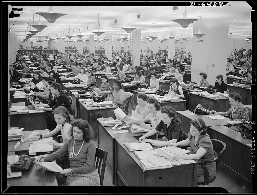 Clerical workers processing forms for production requirement plan, Priorities Division, War Production Board (WPB). Sourced…