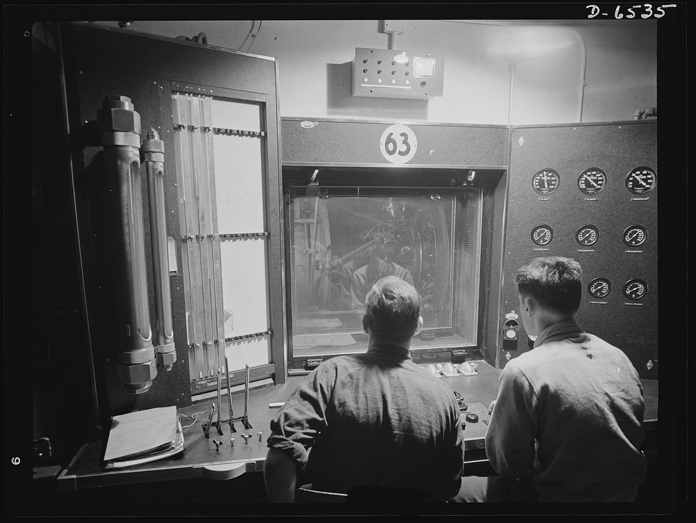 Production. Pratt and Whitney airplane engines. Engineers working at the control panel of a test stand at a large Eastern…