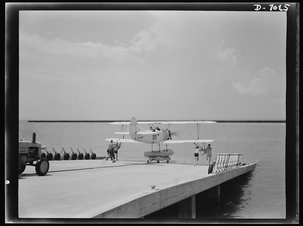 Naval air base, Corpus Christi, Texas. Ready to soar out over the water, this N3N training plane coasts down the plank to…