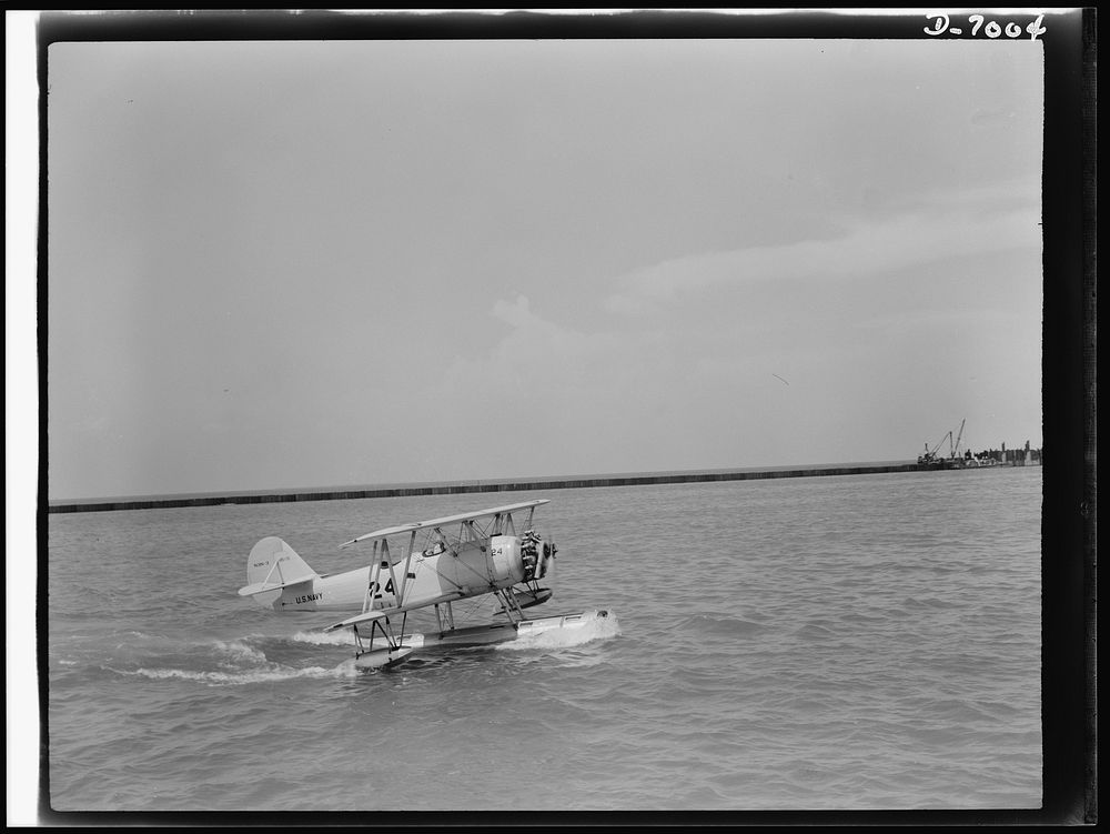 Naval air base, Corpus Christi, Texas. Skimming across the water in a perfect landing, a Navy training ship M2M, approaches…