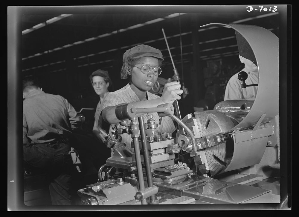Women in war. Supercharger plant workers. Plant foremen point to 20-year-old Annie Tabor as one of their best lathe…