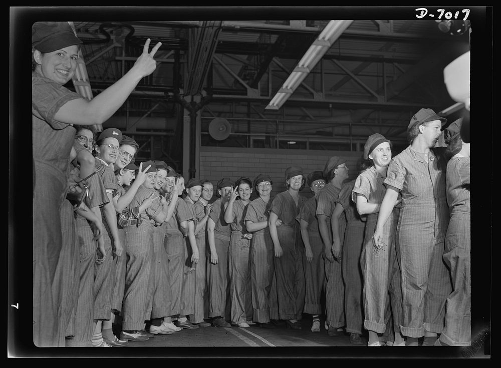 Women in war. Supercharger plant workers. A good day's work done, employees of a large Midwest supercharger plant line up to…