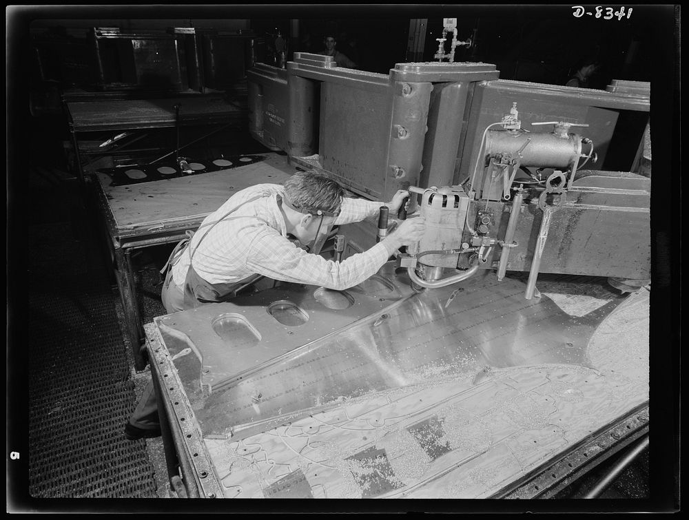 Production. B-17F heavy bomber. Parts for a new B-17F (Flying Fortress) bomber are cut on a routing machine in the Boeing…