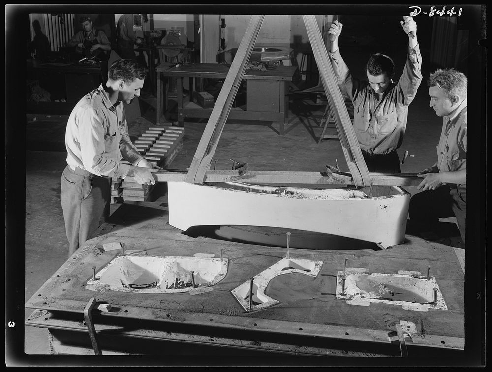 Production. B-17 heavy bomber. Pulling a plaster pattern from a mold for a land die to be used in forming parts for B-17F…