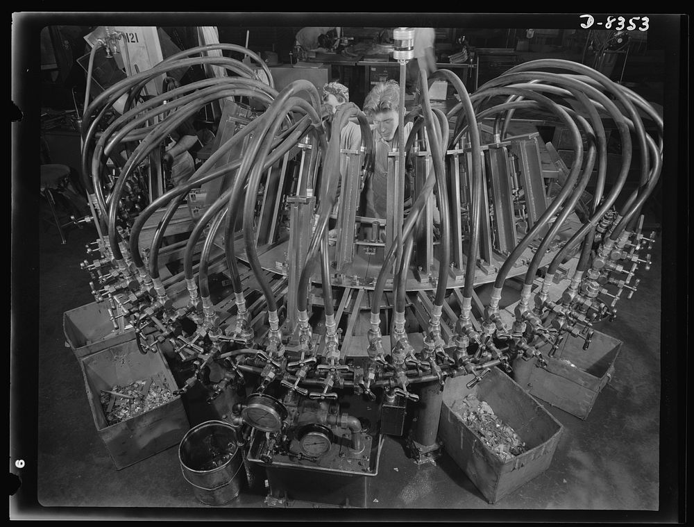 Production. B-17F heavy bomber. Octopus punching machine working on parts for new B-17F (Flying Fortress) bombers at the…