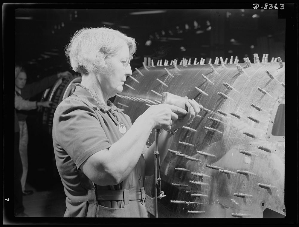 Production. B-17F heavy bomber. Drilling holes in a sub-assembly for a B-17F (Flying Fortress) bomber in the Boeing plant at…